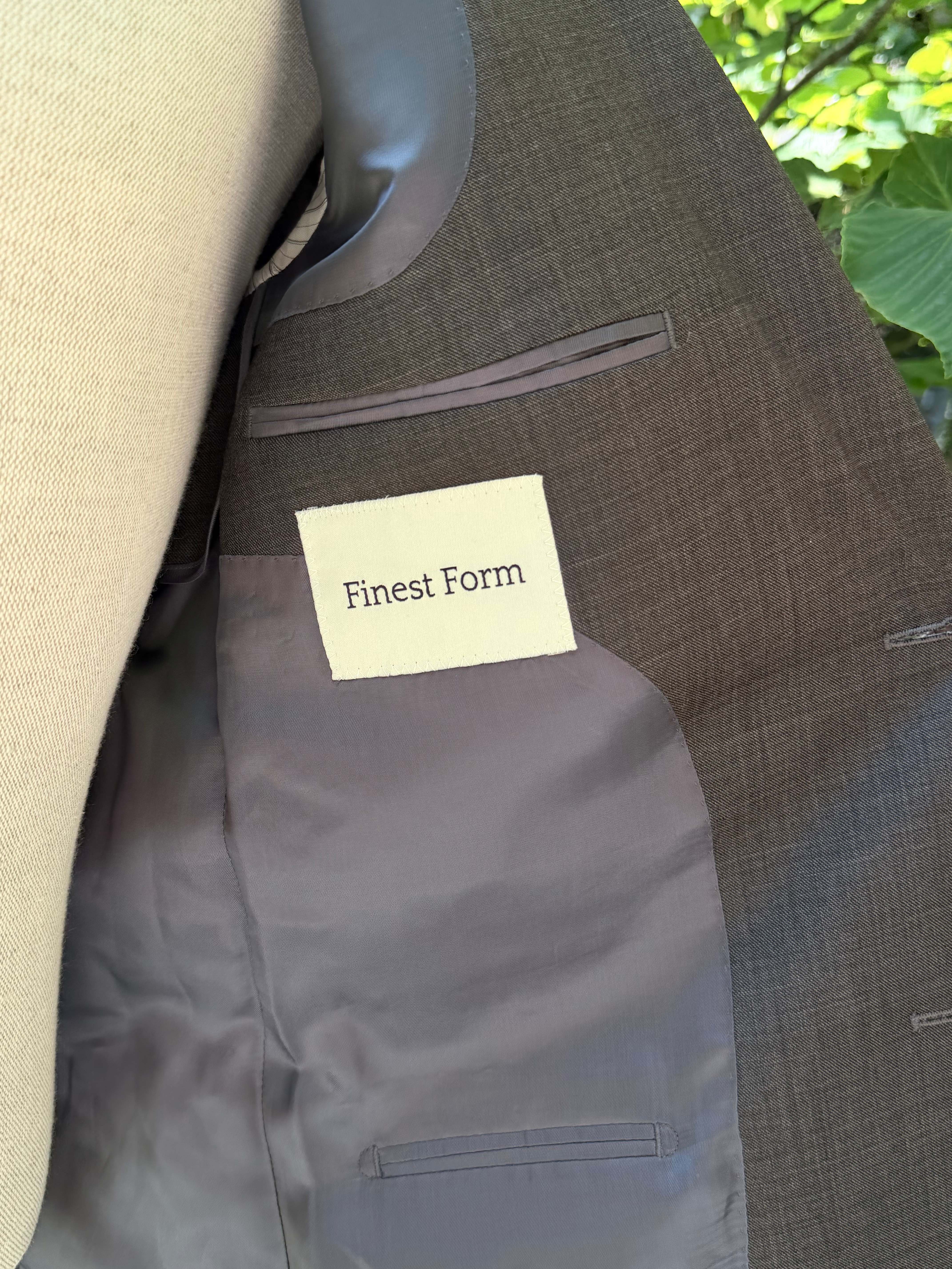 The Finest Form woven label stitched inside the lining of a jacket